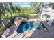 Aerial view of the pool with a slide, waterfall, spa, and a large screened patio at 460 Canterwood Dr, Mulberry, FL 33860
