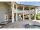 Open-air backyard featuring a covered patio, pool, outdoor kitchen, and spiral staircase at 460 Canterwood Dr, Mulberry, FL 33860