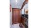 Stylish bar area featuring a built-in wine cooler, dark wood cabinets, and marble countertops at 460 Canterwood Dr, Mulberry, FL 33860