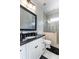 Well-lit bathroom with a granite countertop, white cabinetry, and a glass-enclosed shower at 460 Canterwood Dr, Mulberry, FL 33860