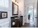 Cozy bathroom features dark wood cabinets, a granite countertop, and a framed mirror with natural light at 460 Canterwood Dr, Mulberry, FL 33860