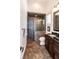 Modern bathroom with a tiled shower, granite countertop, wood cabinets, and framed mirror at 460 Canterwood Dr, Mulberry, FL 33860