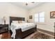 Comfortable bedroom with dark wood furniture, a neutral color palette, and plantation shutters at 460 Canterwood Dr, Mulberry, FL 33860