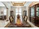 This formal dining room features a long wood table, chandelier, and classic decor, perfect for gatherings at 460 Canterwood Dr, Mulberry, FL 33860
