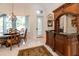 Breakfast nook with bar with chandelier and backyard view, next to built-in bar, for entertaining at 460 Canterwood Dr, Mulberry, FL 33860
