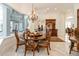 Elegant dining area with chandelier and backyard view, next to built-in bar, for entertaining at 460 Canterwood Dr, Mulberry, FL 33860