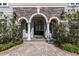 Close up of the beautiful front entryway, featuring a triple arch and stone details at 460 Canterwood Dr, Mulberry, FL 33860