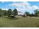 Sprawling estate with lush lawn, mature trees, and a circular driveway with a fountain, offering serene curb appeal at 460 Canterwood Dr, Mulberry, FL 33860