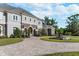 Beautiful home featuring a circular driveway, fountain, manicured lawn, and stone accents at 460 Canterwood Dr, Mulberry, FL 33860