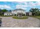 Stately two-story home with fountain, circular driveway, and beautifully landscaped front yard at 460 Canterwood Dr, Mulberry, FL 33860