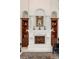 Beautiful fireplace with custom millwork and decorative accents in the living room, flanked by built-in cabinets at 460 Canterwood Dr, Mulberry, FL 33860