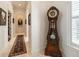 Hallway featuring a marble floor, elegant arches, and ornate grandfather clock at 460 Canterwood Dr, Mulberry, FL 33860