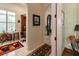 Hallway featuring a desk, a painting, a patterned rug, and tile flooring at 460 Canterwood Dr, Mulberry, FL 33860