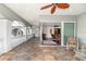 Upper level hallway featuring elegant railing, tile flooring, seating, and access to a sunlit room at 460 Canterwood Dr, Mulberry, FL 33860