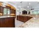Gourmet kitchen featuring custom wood cabinetry, granite countertops and backsplash, open to living area at 460 Canterwood Dr, Mulberry, FL 33860