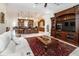 Inviting living room featuring an open floorplan, rich wood accents, and a cozy seating area with white sofa at 460 Canterwood Dr, Mulberry, FL 33860