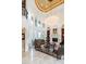 Elegant living room with fireplace, chandelier, marble floors and high ceilings at 460 Canterwood Dr, Mulberry, FL 33860
