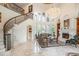 Spacious living room with a grand staircase, fireplace, chandelier and marble floors at 460 Canterwood Dr, Mulberry, FL 33860
