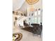 Luxury living room boasts soaring ceilings, elegant chandelier, and curved staircase with ornate iron railings at 460 Canterwood Dr, Mulberry, FL 33860