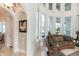 Bright living area filled with natural light from large windows, showcasing elegant seating at 460 Canterwood Dr, Mulberry, FL 33860