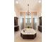 Main bathroom has an elegant tub as the focal point, with double vanities and walk-in showers at 460 Canterwood Dr, Mulberry, FL 33860
