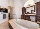 Expansive main bathroom featuring a jetted tub, custom vanities, and modern lighting at 460 Canterwood Dr, Mulberry, FL 33860