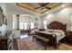 Spacious main bedroom with detailed ceiling, hardwood floors, and a luxurious sitting area at 460 Canterwood Dr, Mulberry, FL 33860