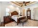 Main bedroom showcases a beautiful wood bed frame, hardwood floors, and a decorative ceiling at 460 Canterwood Dr, Mulberry, FL 33860