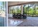 A covered outdoor dining area with seating for eight offers the perfect setting for al fresco meals with lush green views at 460 Canterwood Dr, Mulberry, FL 33860