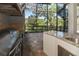 This outdoor kitchen features modern appliances and countertop space, perfect for grilling and outdoor entertaining at 460 Canterwood Dr, Mulberry, FL 33860