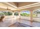 Expansive covered patio with tile flooring, ceiling fan, decorative railing, and scenic views at 460 Canterwood Dr, Mulberry, FL 33860