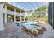 Beautiful backyard pool area with rock features, a waterfall, and lush landscaping at 460 Canterwood Dr, Mulberry, FL 33860