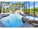 Crystal clear enclosed pool, a waterfall feature, and surrounding patio at 460 Canterwood Dr, Mulberry, FL 33860