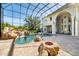 Enclosed pool area with waterfall and a slide for backyard Gathering fun and adventure at 460 Canterwood Dr, Mulberry, FL 33860