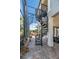 A black spiral staircase overlooks the enclosed pool with a waterfall, lush landscape, and outdoor entertaining space at 460 Canterwood Dr, Mulberry, FL 33860