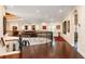 Spacious upper level hallway with hardwood floors, elegant staircase, art displays, and natural light at 460 Canterwood Dr, Mulberry, FL 33860