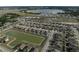 Community aerial view with a central pond surrounded by similar single Gathering homes at 4886 St James Ln, Winter Haven, FL 33881