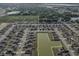 Expansive aerial view of a neighborhood with a central pond and well-maintained lawns at 4886 St James Ln, Winter Haven, FL 33881