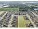 An aerial view showcases a well-planned community with a central pond and neatly arranged single-Gathering homes at 4886 St James Ln, Winter Haven, FL 33881
