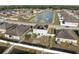 Home with solar panels, a small backyard, and a community pond nearby at 4886 St James Ln, Winter Haven, FL 33881