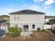 Back of house, showing solar panels and a patio with a grill at 4886 St James Ln, Winter Haven, FL 33881