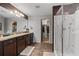 Bathroom with double sink vanity, walk-in shower, and a large closet at 4886 St James Ln, Winter Haven, FL 33881