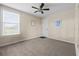 Well-lit bedroom featuring a ceiling fan, neutral walls, and a large window at 4886 St James Ln, Winter Haven, FL 33881