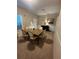 An inviting dining room featuring a wooden table with seating for six, complemented by neutral decor and ample natural light at 4886 St James Ln, Winter Haven, FL 33881