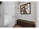 Entryway with a modern storage bench, unique flooring, wall art, and decorative trim at 4886 St James Ln, Winter Haven, FL 33881