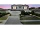 Charming two-story home with gray siding, well-manicured lawn, and a convenient two-car garage at 4886 St James Ln, Winter Haven, FL 33881