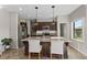 Bright kitchen with a large island, granite counters, stainless steel appliances, and dark wood cabinetry at 4886 St James Ln, Winter Haven, FL 33881