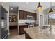 Kitchen featuring dark wood cabinetry, stainless steel appliances, and granite countertops at 4886 St James Ln, Winter Haven, FL 33881