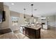 Open kitchen with a large island, granite counters, stainless steel appliances, and access to living area at 4886 St James Ln, Winter Haven, FL 33881