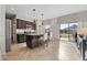 Bright kitchen boasts dark wood cabinetry, tile floors, granite counters, and stainless steel appliances at 4886 St James Ln, Winter Haven, FL 33881